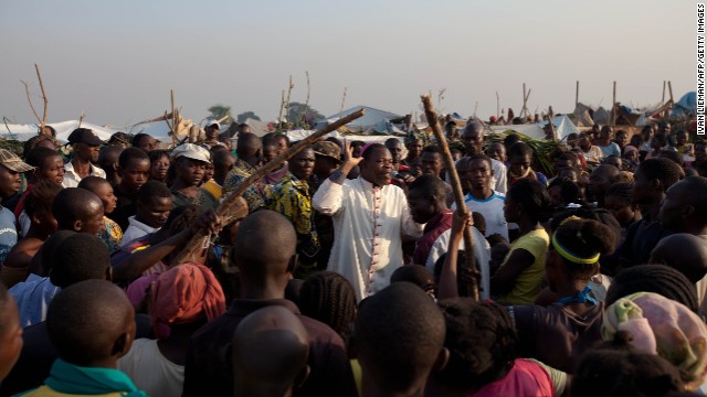 The Archibishop of Bangui, Dieu Donne Nzapa Lainga preaches on Saturday, December 14 to people gathering at a refugee camp close to the Bangui airport. France has begun a military operation in the nation and has been dealing with violence since a March coup. U.S. military aircraft will begin flying African and European peacekeepers into the country, which is in the midst of a bloody civil war between various Christian and Muslim militias and other rebel factions.