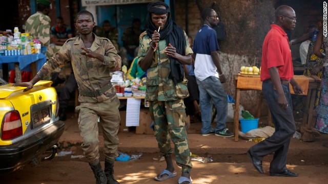 A Seleka presidential guardsman smokes at the downtown market in Bangui, Central African Republic, on December 14. 