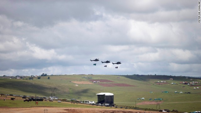 Three helicopters fly over the grave site of former South African President Nelson Mandela as his family lays his body to rest in his hometown of Qunu, South Africa, on Sunday December 15. Mandela's body traveled from Pretoria by air to Mthatha in Eastern Cape province, and then by road to Qunu, where was buried Sunday. Mandela died December 5 at his home in Houghton at the age of 95. 
