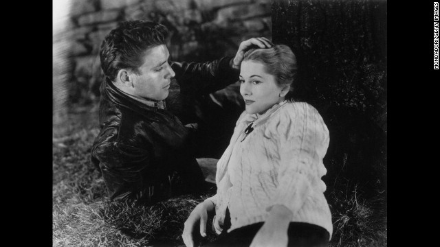 Burt Lancaster caresses Fontaine's head in the 1948 film "Kiss the Blood Off My Hands."