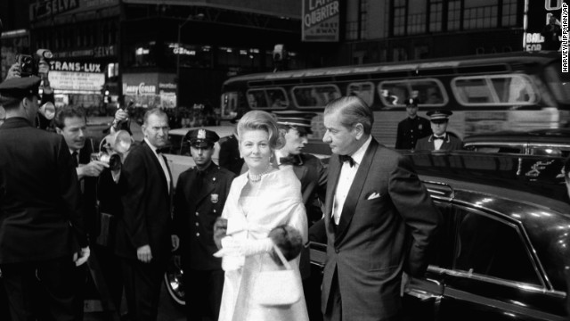 Fontaine, escorted by Charles Addams, arrives at the Rivoli Theater in 1963 for the world premiere of the film "Cleopatra" in New York.