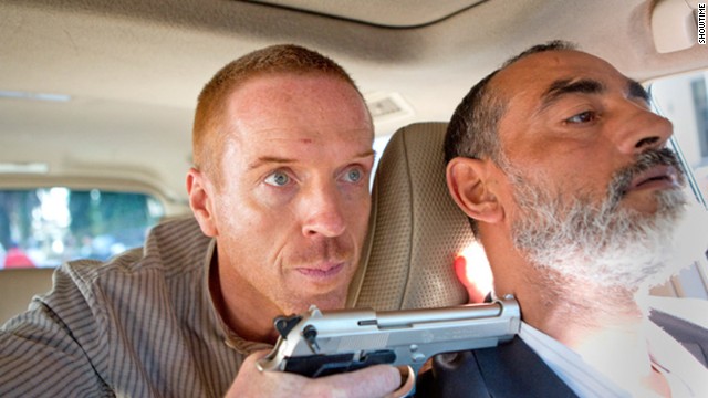 Damian Lewis as Nicholas Brody holds a gun on a driver in a scene from season 3 of Showtime's series 