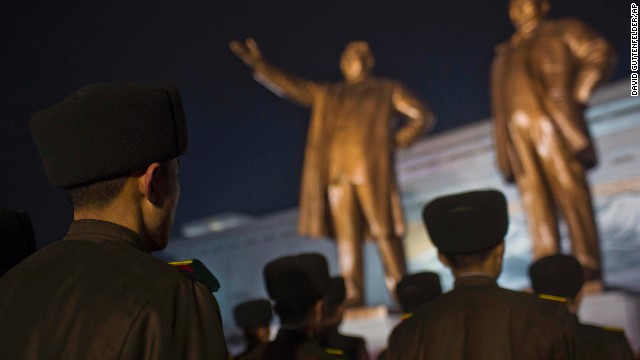 North Korean soldiers pay their respects at the base of statues of the late leaders Kim Il Sung and Kim Jong Il in Pyongyang. 