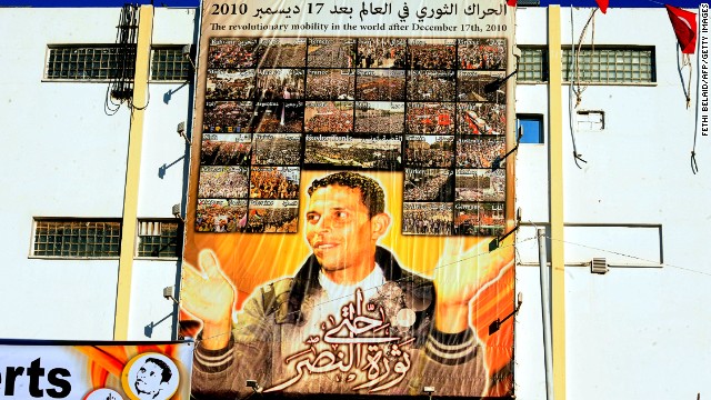 A giant portrait of Mohamed Bouazizi hangs on the wall in the central town of Sidi Bouzid.<a href='http://cnn.com/2011/WORLD/africa/01/16/tunisia.fruit.seller.bouazizi/'> The 26-year old fruit seller who struggled with poverty </a>set himself on fire in front of a government building on December 17, 2010 sparking riots across the country. Al Bouazizi died of his injuries on January 4, 2011.
