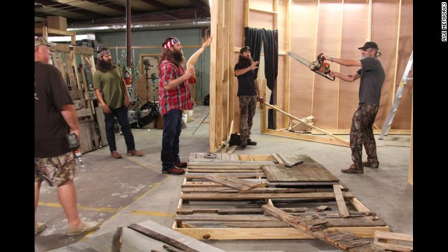 The Duck Commander crew works on transforming their warehouse into a "scarehouse" during a recent Halloween episode. Holding the chainsaw is Si Robertson, who founded the company along with his brother Phil, not pictured. 