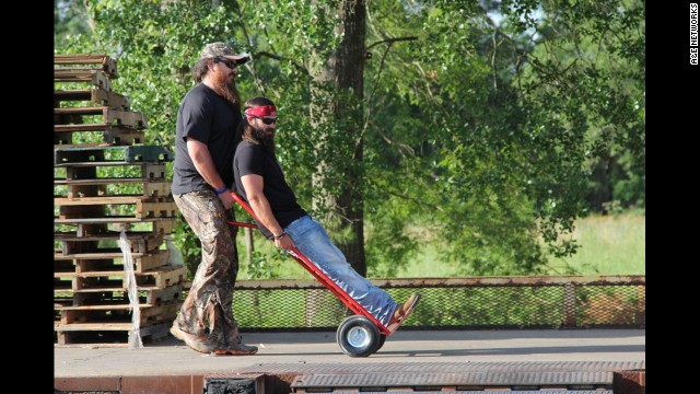 Jep Robertson, one of Willie's brothers and Phil's sons, is pushed along by Duck Commander employee Justin Martin.