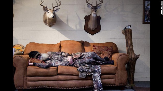 Si takes one of his daily naps, surrounded by some Robertson family trophies.