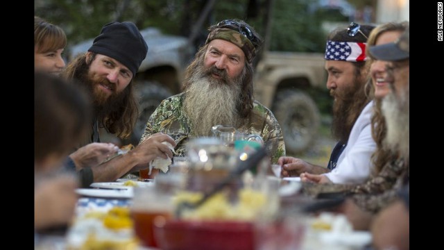 Phil takes his place at the head of the table. A family dinner is the typical scene that ends each episode.