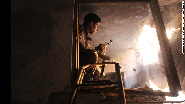 Free Syrian Army fighters sit in a damaged house in Old Aleppo on Saturday, December 21. 