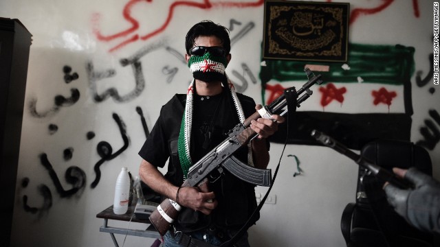 A Syrian opposition fighter poses with his AK-47 in Aleppo, Syria, in 2012.