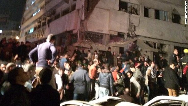 One blast occurred on one of the top floors of the building and was followed by a car bomb, MENA reported.