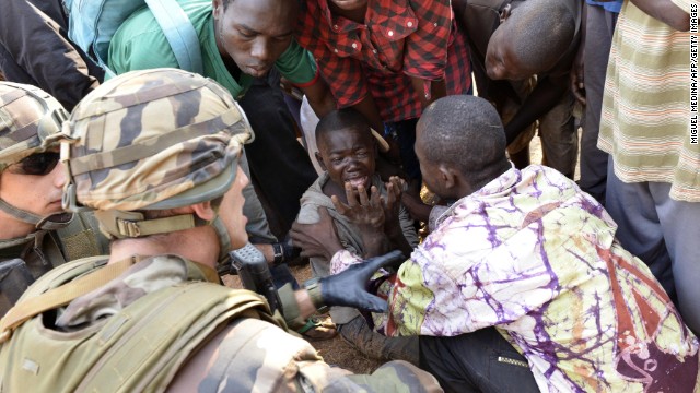 French troops and civilians try to comfort a crying boy near the airport in Bangui on December 23.