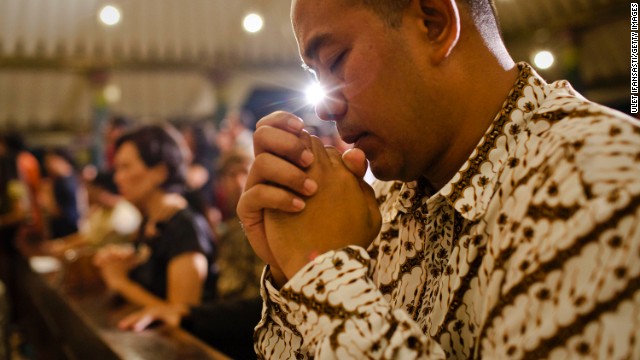 An Indonesian Javanese Christian prays during Christmas Eve Mass in Yogyakarta, Indonesia, on December 24.