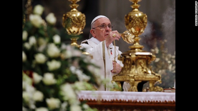 The Pope waves incense during the celebration.