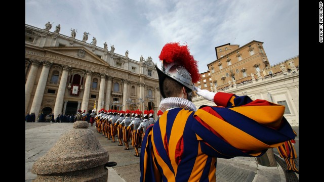 Swiss guards march prior to the start of the Pope's message.