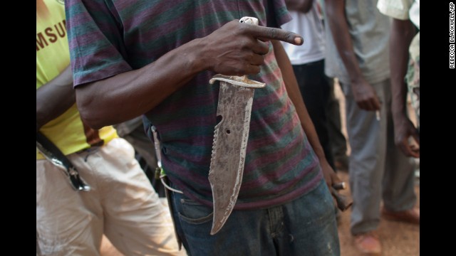 A militiaman holds a knife as he describes a recent attack in Bangui on Tuesday, December 24.