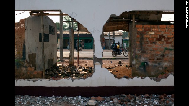 A motorcycle passes the remains of a mosque destroyed earlier in the month in Bangui on Monday, December 23.