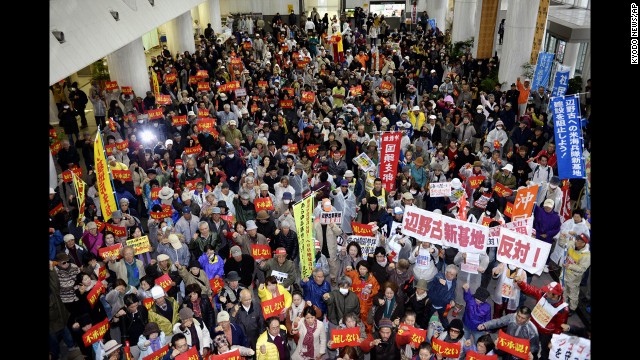 Hundreds of protesters stage a rally opposing the approval of the relocation in the lobby of Okinawa prefecture's government building in Naha on Friday, December 27. The Futenma air base, which is in a highly populated area, has been unpopular with the island's residents because of crimes committed by U.S. military personnel and allegations against them in the past.