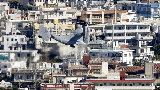 An Osprey tilt-rotor aircraft flies over Ginowan on August 3, heading for the Futenma Air Station for additional deployment. The stagnation of the relocation issue has been a thorn in the side of relations between Tokyo and Washington since 1996, when the two governments agreed on the original plan to move the base.