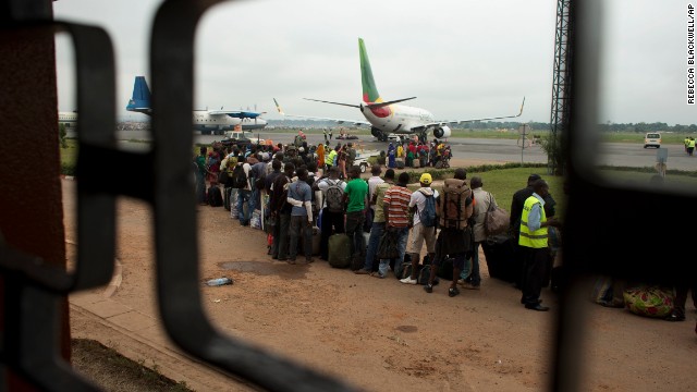 Cameroonians wait in line to board an evacuation flight at M'Poko Airport, which is guarded by French soldiers, in Bangui on December 27. Military escorts shuttled citizens of Chad and Cameroon to the airport Friday to board evacuation flights as French troops stepped in to help Muslims fleeing north by road.