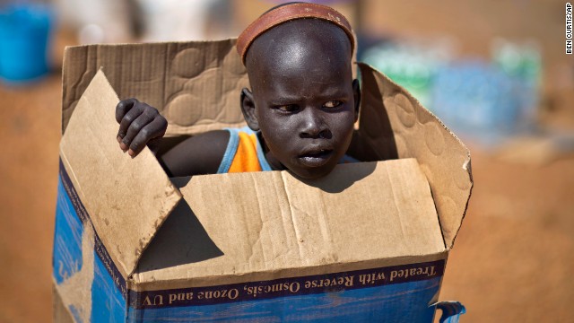 A displaced boy carries a cardboard box inside a U.N. compound in Juba on Friday, December 27.