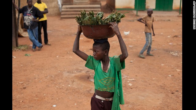 A young boy watches as people hurl rocks at passing vehicles carrying fleeing Muslims in the Gobongo neighborhood of Bangui on December 27.