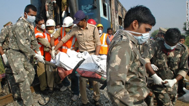 Indian rescuers carry away a victim of the deadly train fire.