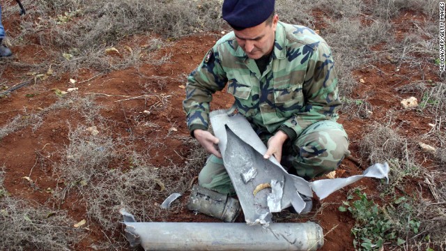 A Lebanese soldier examines of one 20 the shells that were fired by the Israeli army into southern Lebanon on December 29, 2013.