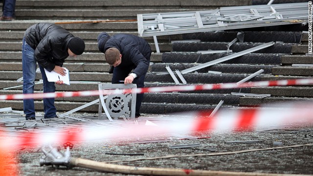 Police investigators inspect debris at the scene of the explosion.