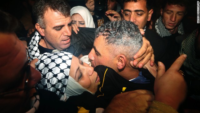 Rami Barbakh, a released Palestinian prisoner, center, is reunited with his mother in the northern Gaza town of Beit Hanoun.