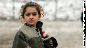 A Syrian girl plays in the city of Aleppo, bombed two days after this photo was taken on December 13.\n