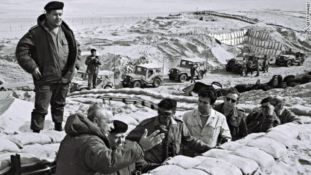 Former Prime Minister David Ben-Gurion is briefed in 1971 by Sharon in a trench near the Suez Canal in the Sinai.<!-- --> </br> 