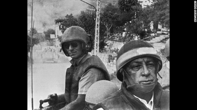 Israeli Defense Minister Ariel Sharon, in combat helmet and flak jacket, leads his troops toward a meeting with Christian forces in East Beirut in June 1982. Israel had invaded southern Lebanon in retaliation for an assassination attempt linked to the group Abu Nidal.