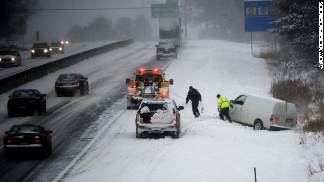 A van is pulled from a ditch along Interstate 94 in Jackson, Michigan, on January 2.