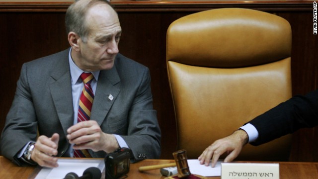 Acting Prime Minister Ehud Olmert looks toward the empty chair of Prime Minister Ariel Sharon as a note is passed to him during a special meeting of the cabinet in April 2006. Israel's Cabinet declared Sharon permanently incapacitated, a decision marking the official end of his five-year tenure. Sharon suffered his stroke in January 2006 and was in a coma. 