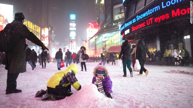 Children make a snow pile in New York's Times Square on January 2.