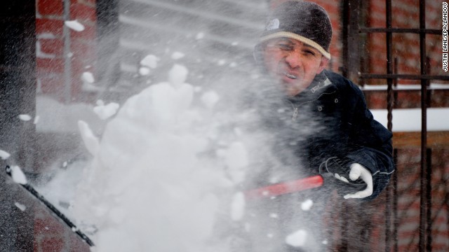 A man shovels snow during the tail end of a snowstorm in Brooklyn on January 3.