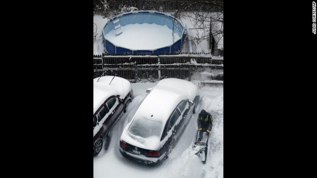 A man plows snow January 3 following an overnight snowstorm in Jersey City, New Jersey.