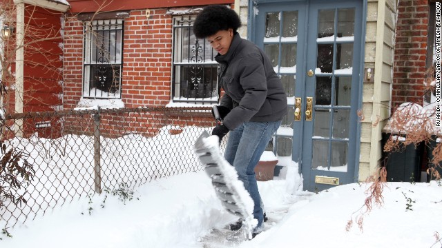 Dante de Blasio, son of New York Mayor Bill de Blasio, shovels snow outside his home in Brooklyn on January 3.