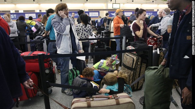 Travelers wait in line January 3 at Chicago Midway International Airport.