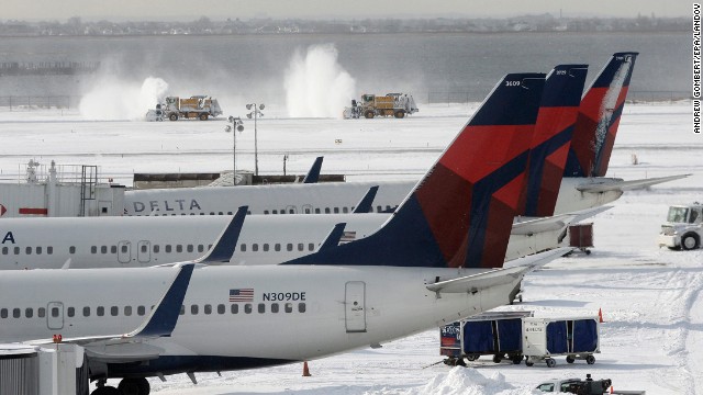 Snowplows clear snow from one of the runways at John F. Kennedy International Airport in New York on January 3.