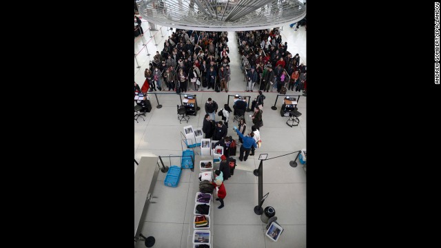 Passengers wait in line at a security checkpoint at JFK Airport on January 3.