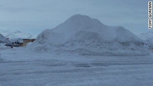 America\'s snow capital piles some of the plowed snow into a snow cone in a parking lot near city hall.