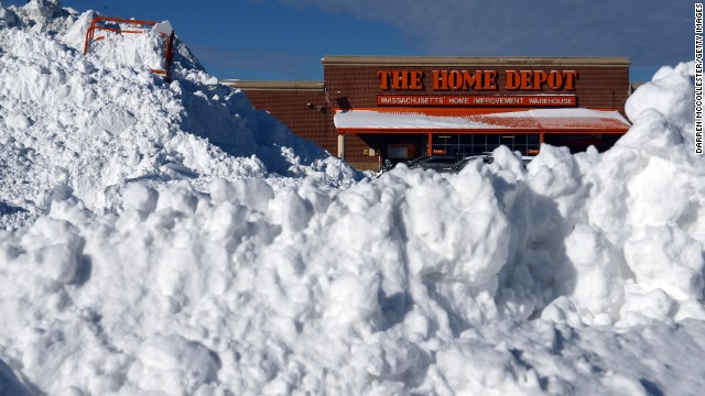 Snow is piled high in front of a Home Depot in Boston on January 4 after a two-day winter storm.