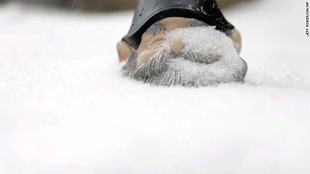 Snow covers a garden gnome in St. Louis on January 5.