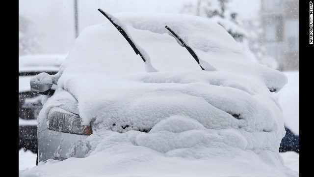 A car is buried in snow January 5 in Zionsville, Indiana.