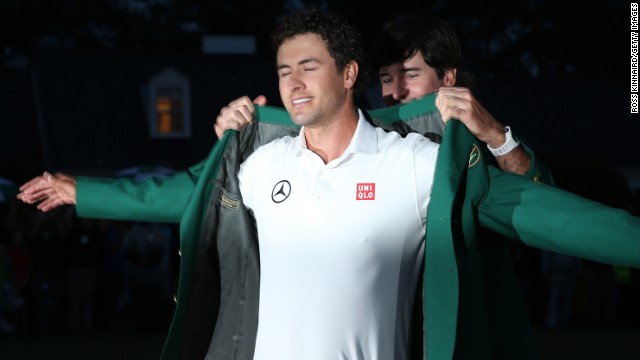 Bubba Watson helps Scott don the green jacket at the 2013 Masters after the Australian won his first major after a playoff with Angel Cabrera. 