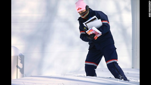 Postal worker Jamie Jasmon struggles to deliver mail in the snow January 6 in Springfield, Illinois.