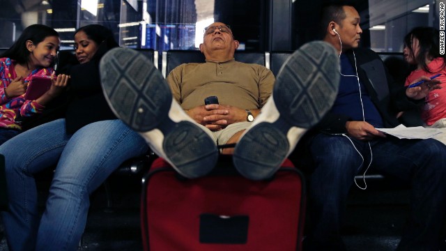 A man takes a nap at Logan International Airport after his flight was canceled Monday, January 6.