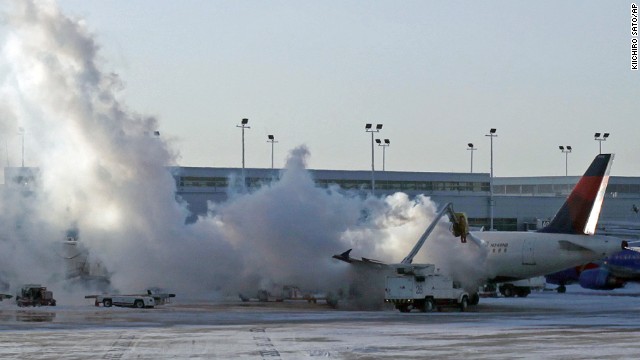 A Delta Air Lines plane is de-iced at Chicago Midway International Airport on January 6.